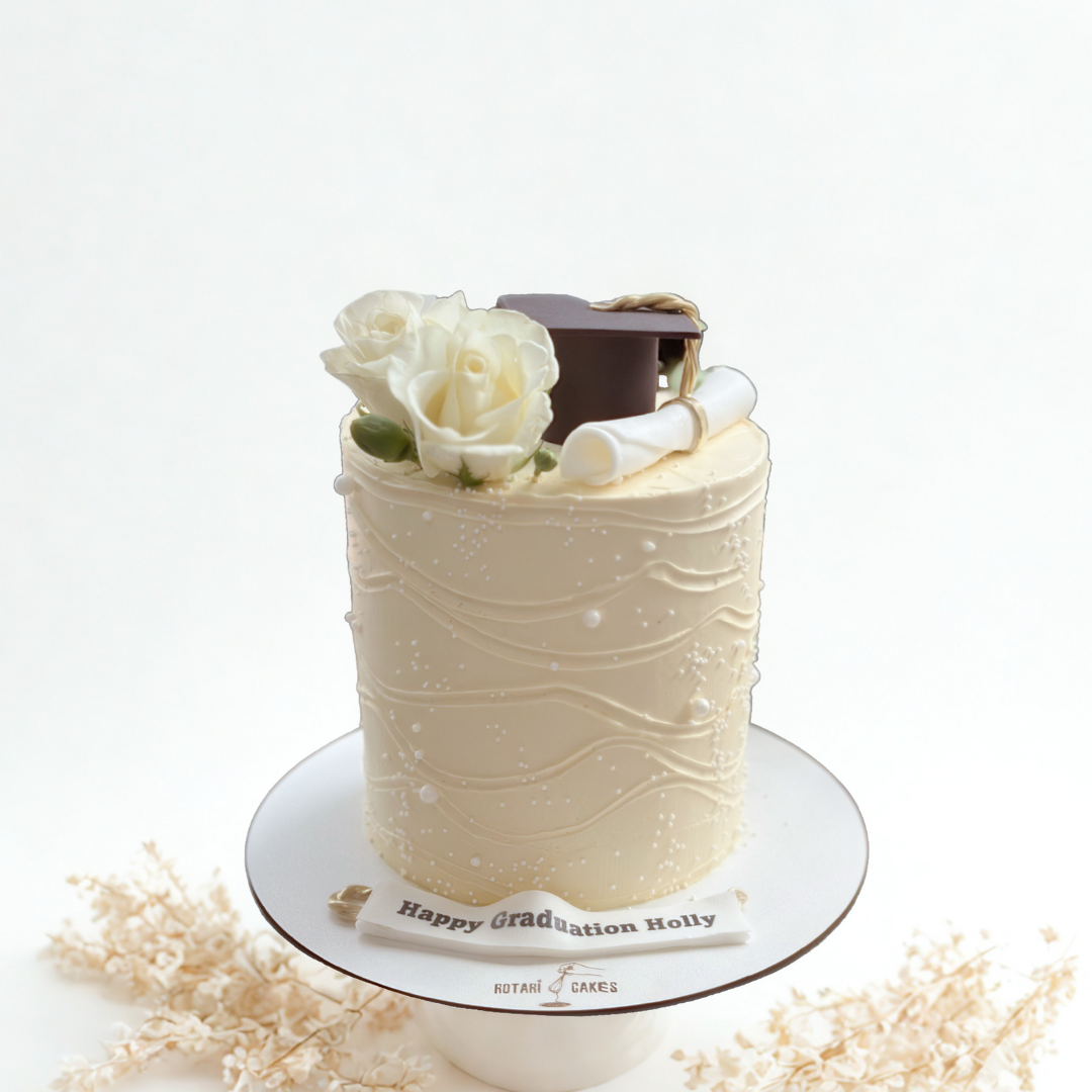 Graduation cake with edible graduation cap and scroll decorations, perfect for high school and university celebrations.