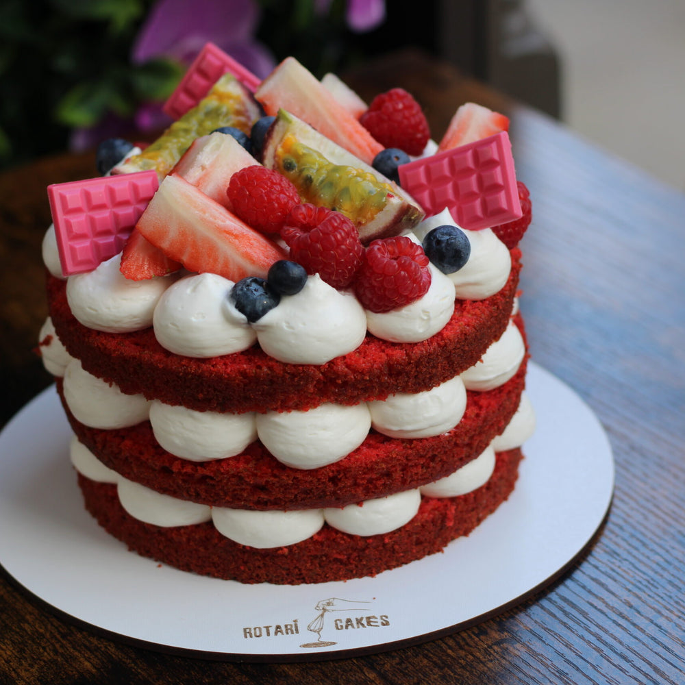 Naked Red Velvet Cake with creamy cream cheese frosting and exposed layers, ideal for birthdays and intimate celebrations.