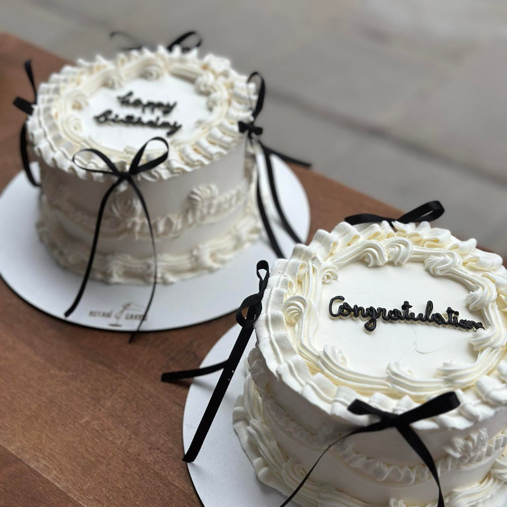 Mini Piping Cake  in white colour with black ribbons