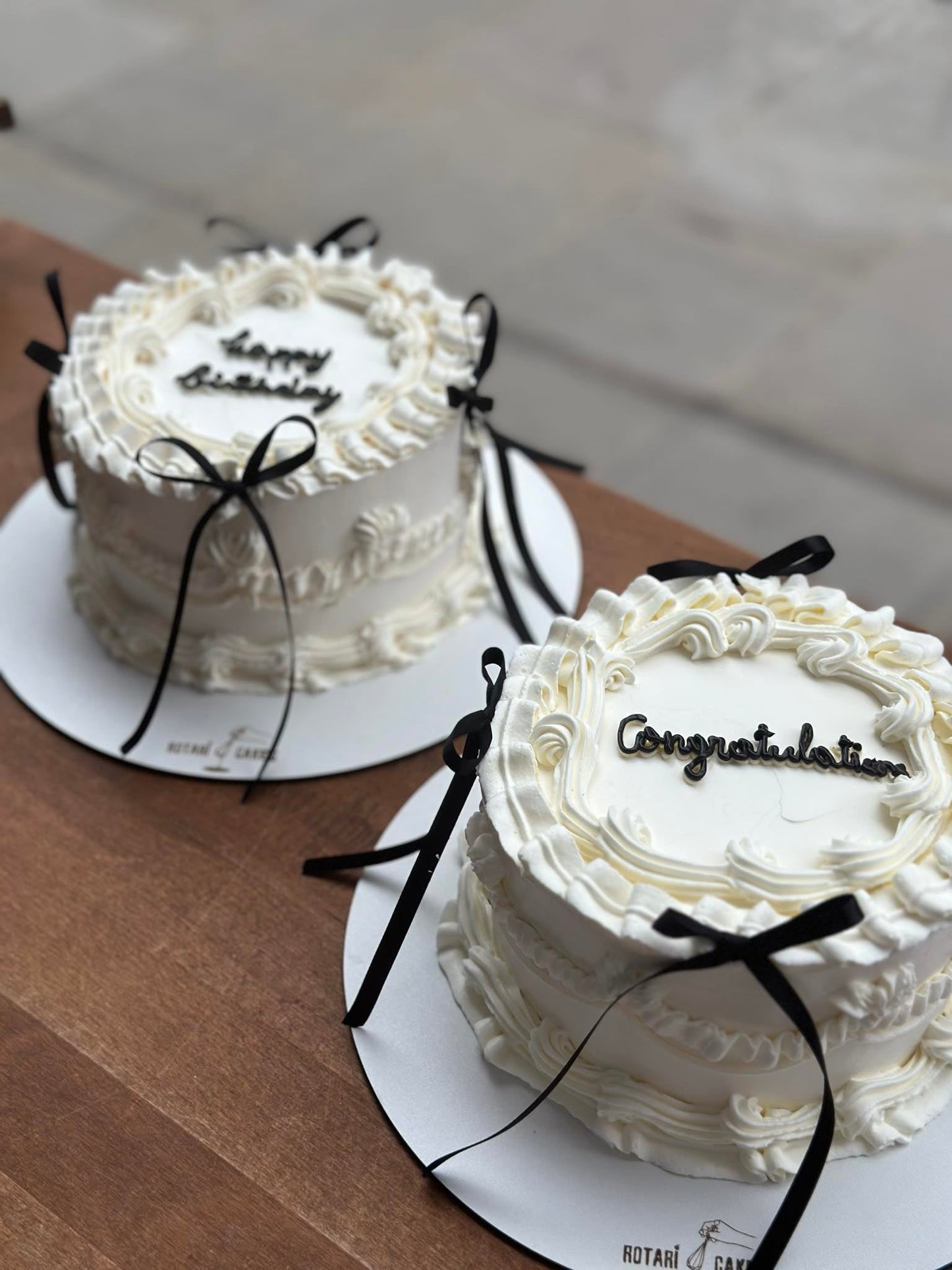 Mini Piping Cake  in white colour with black ribbons
