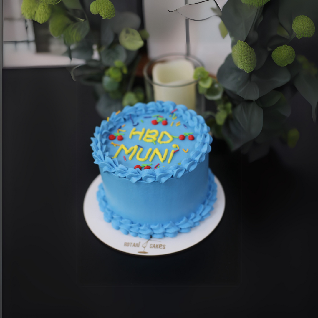 blue colour mini birthday cake with cherries and custom text on top