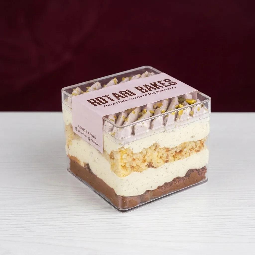 Almond pistachio_Belgian chocolate cake in a small acrylic container for nationwide delivery