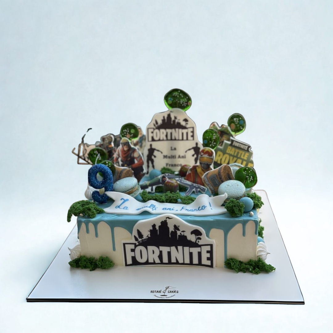 Fortnite-themed birthday cake with character figures and decorative elements on a white background