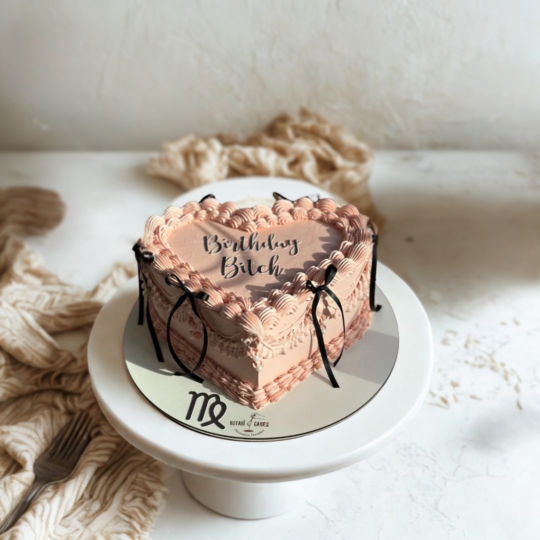 Heart-shaped cake with 'Birthday Bitch' text on the cake