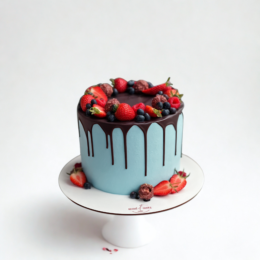 blue colour cake with berries on top and chocolate ganache for girls birthdays and other occasions