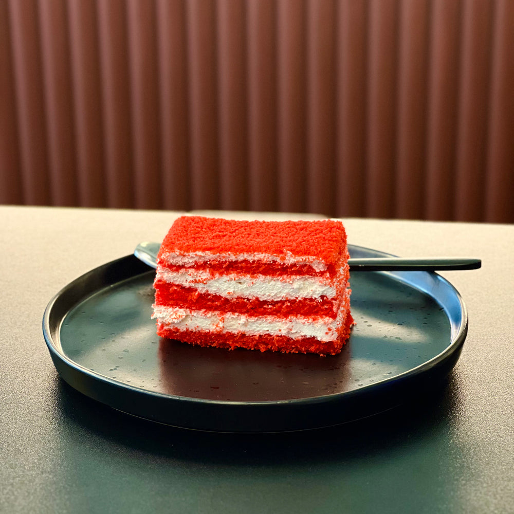 Red Velvet Slice Cake with deep red sponge, cream cheese and sour cream frosting, and a glossy jelly topping