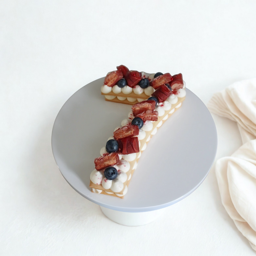 Number 7 cake slice with berries on a white plate- Number cake