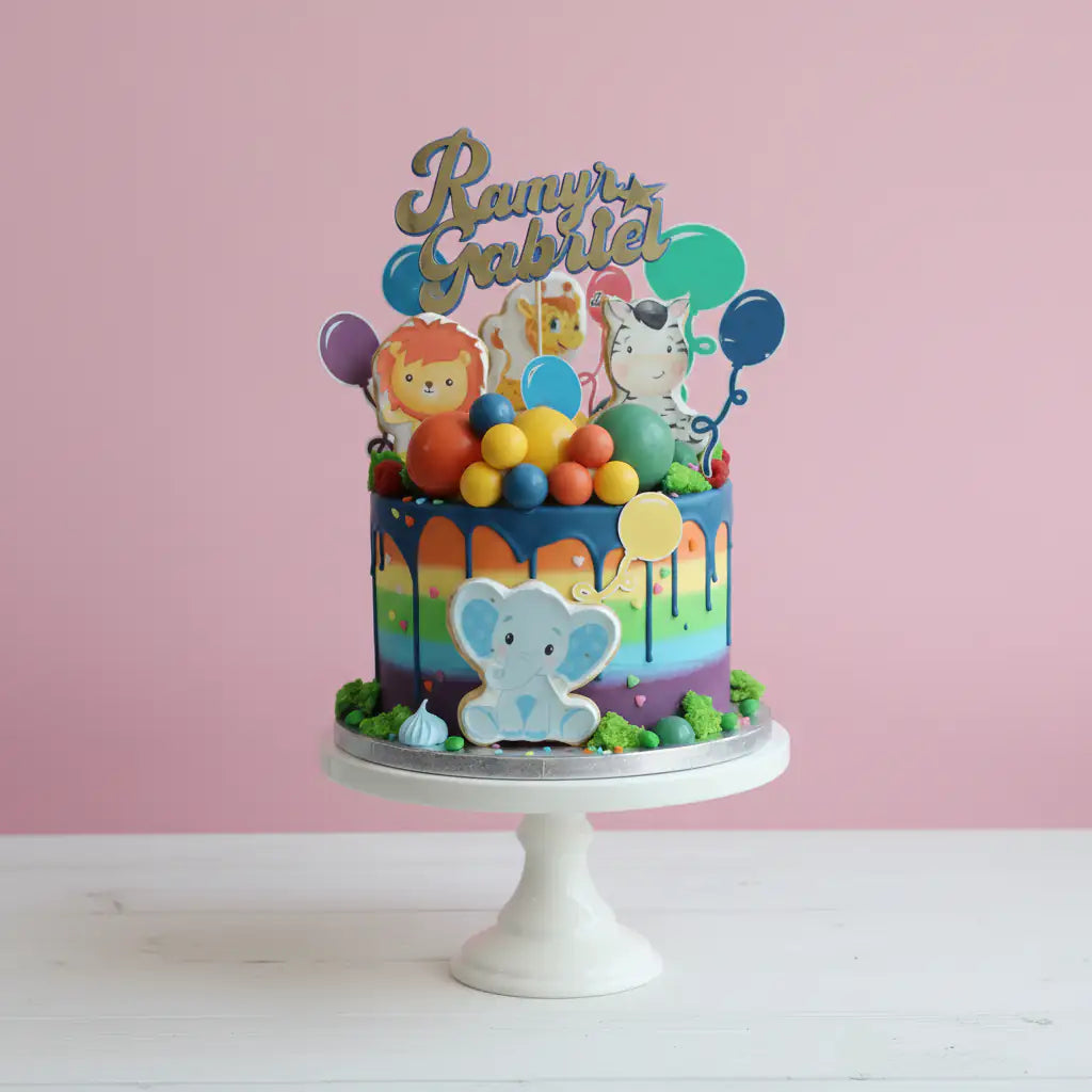 Colorful children's safari birthday cake with animal-themed decorations on a pink background