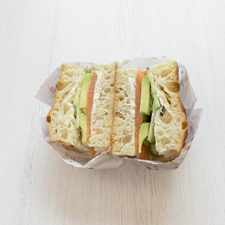 half sliced salmon focaccia sandwich