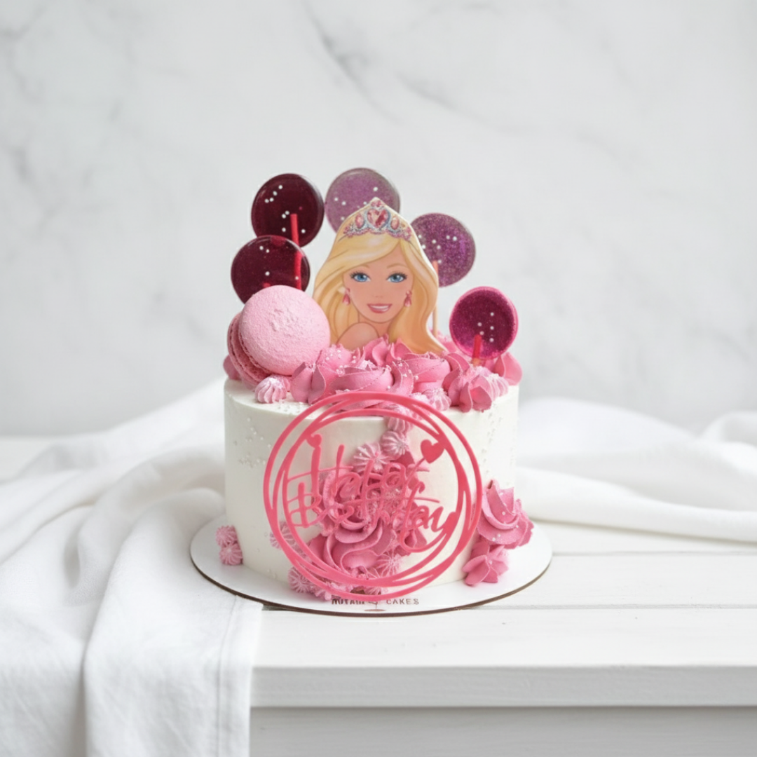 Pink barbie themed cake with a doll figure and balloons on a white background