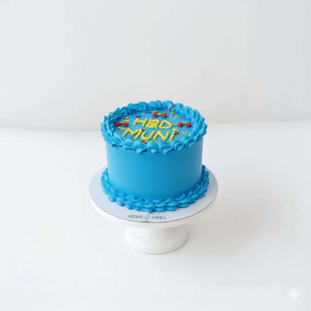 Blue cake with 'HBD Muni!' on a white stand against a white background