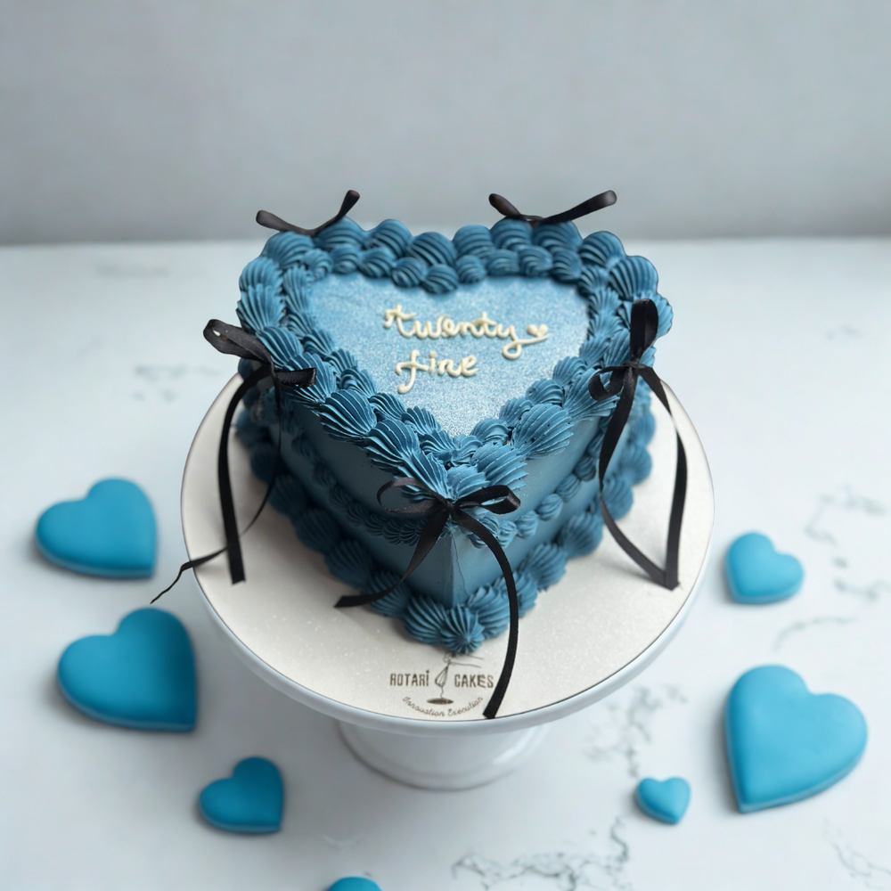 blue heart shape cake with bows in vintage piping style