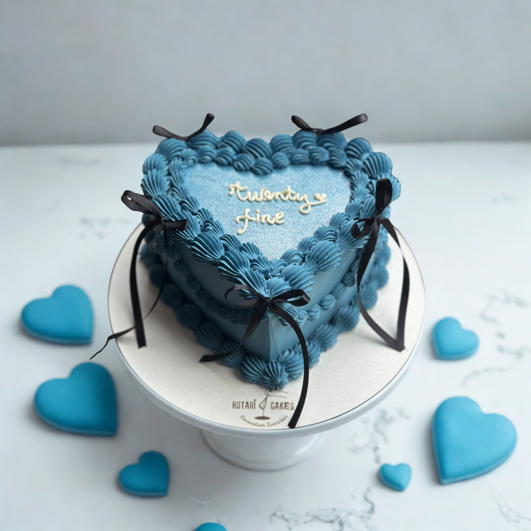 blue heart shape cake with bows in vintage piping style