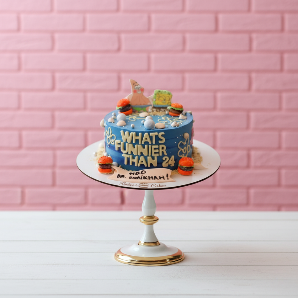 Birthday cake with text and decorations on a white stand against a pink brick wall.