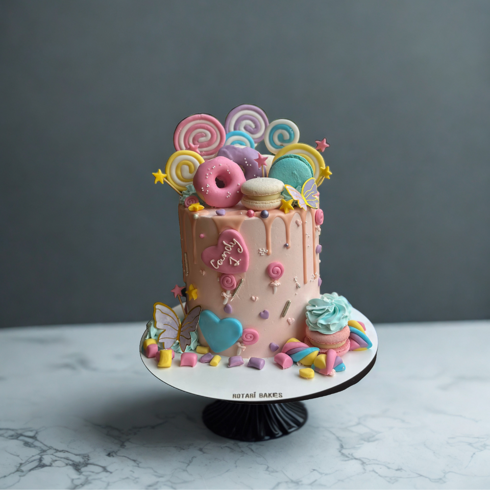 Colorful candyland cake with decorative candy elements 