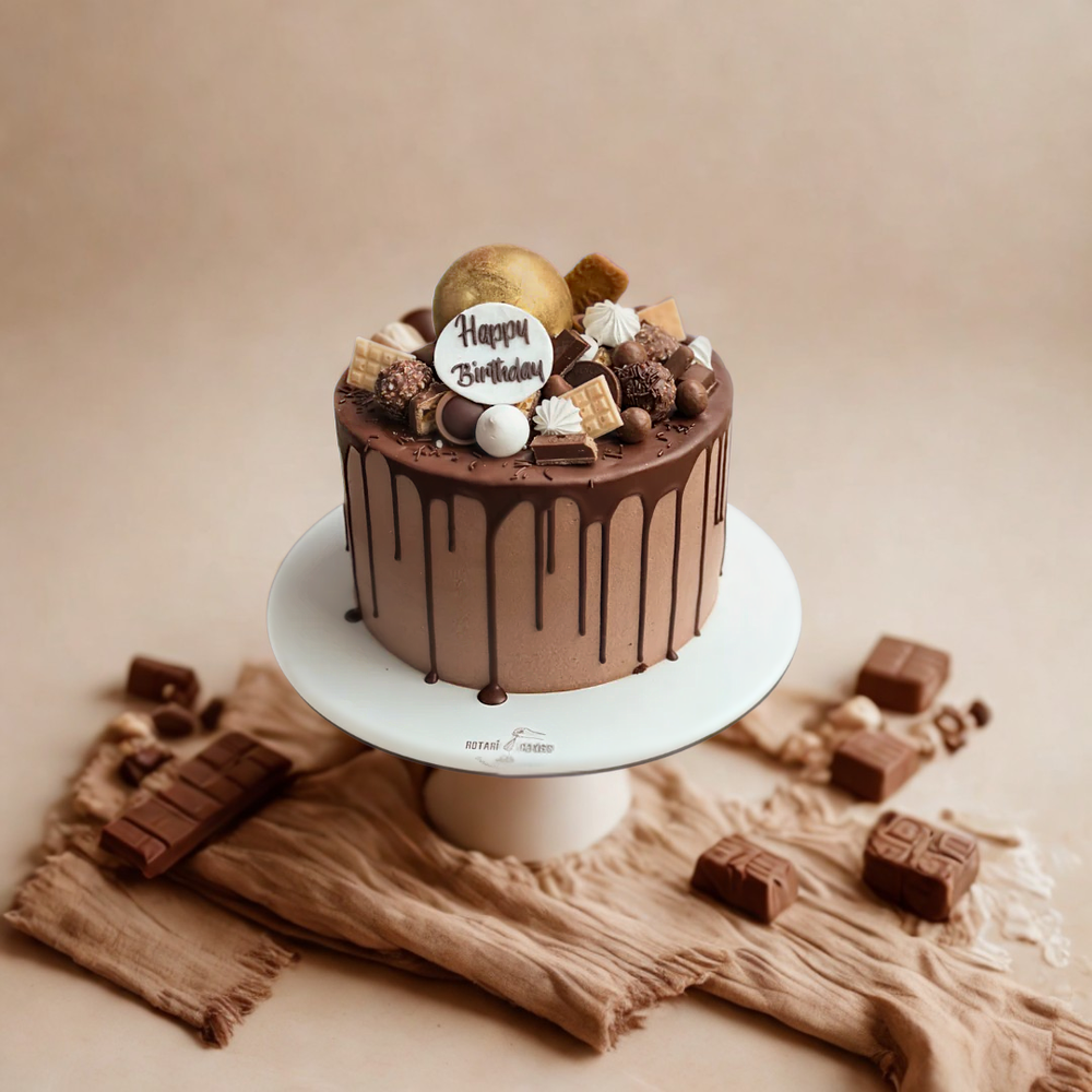 Chocolate birthday cake with decorative elements on a beige background