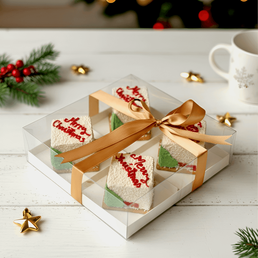christmas desserts in white colour with red writing of merry christmas and christmas tree on the cake perfect for christmas gift