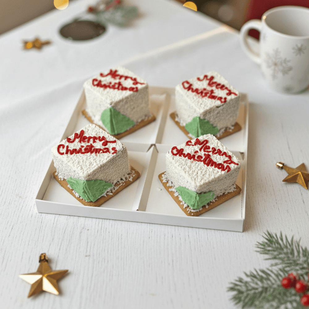 christmas cube desserts in white colour with red writing of merry christmas and christmas tree on the cake