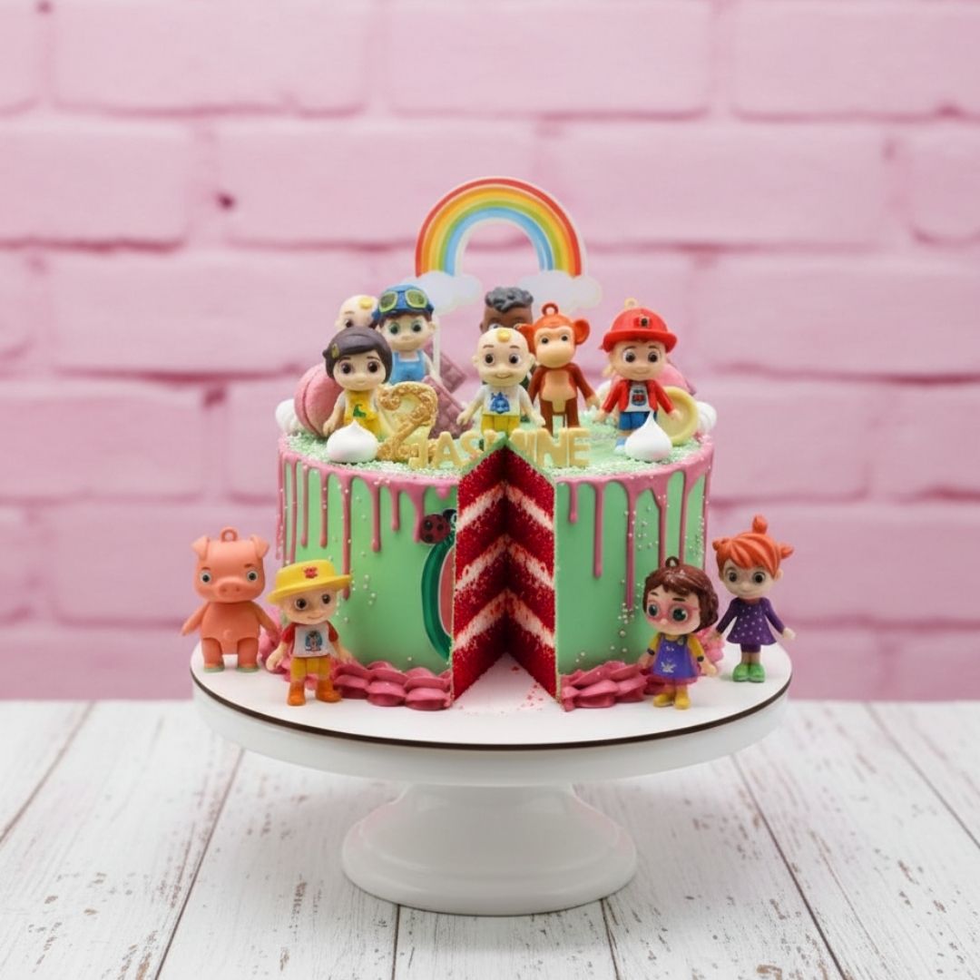 cocomelon theme Colorful birthday cake with toy figures and a rainbow on a pink brick wall background