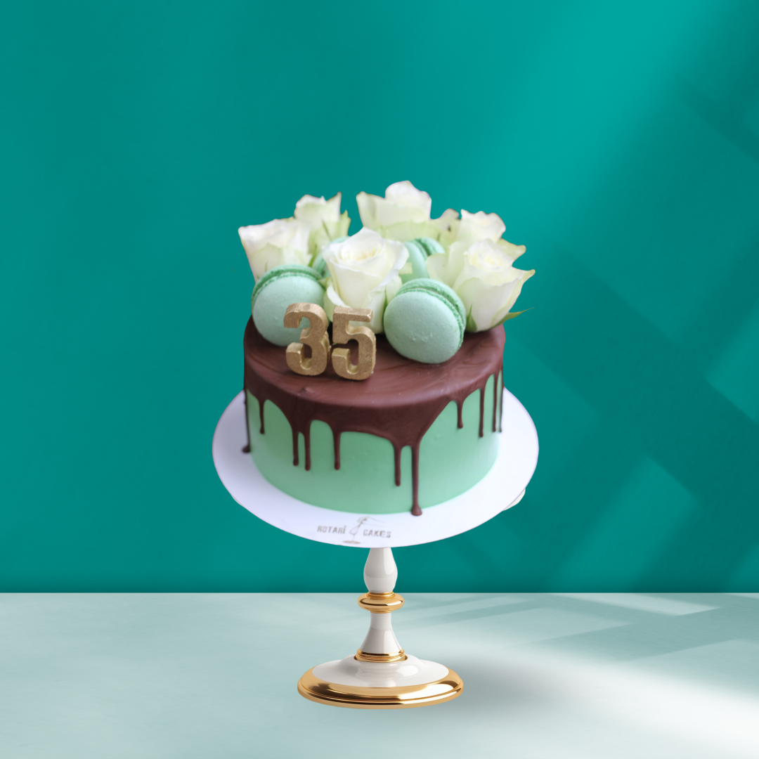 green cake with chocolate ganache on top and white flowers for 35th birthday 