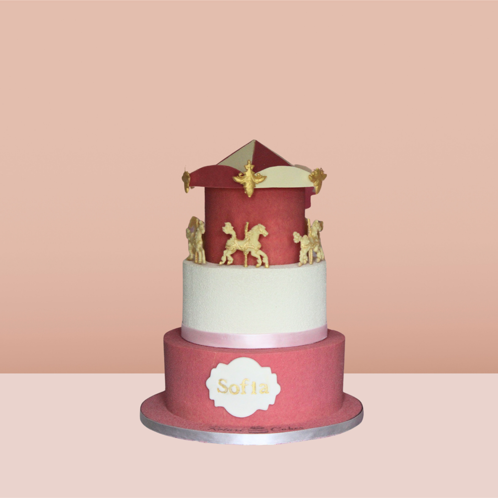 
                  
                    Three Tier Horses Carousel Cake by Rotari Bakes with pastel colours, gold accents, and carousel horse toppers
                  
                