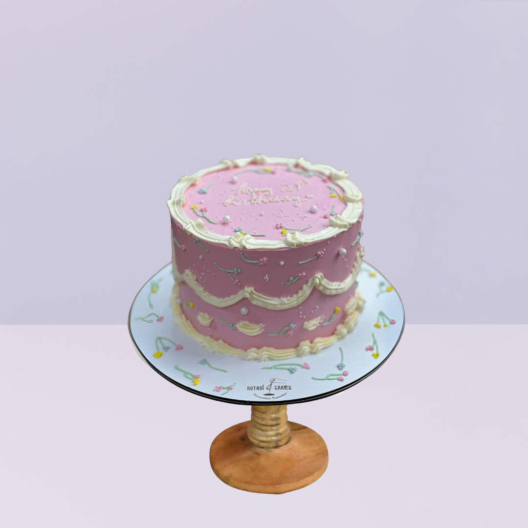 small cake in pink colour with piping design