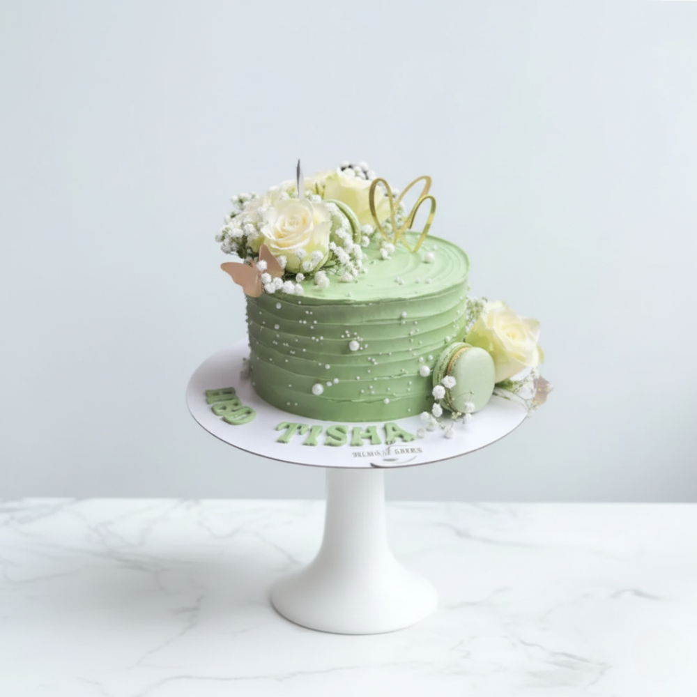 green cake with flowers and macarons for birthdays and other celebrations