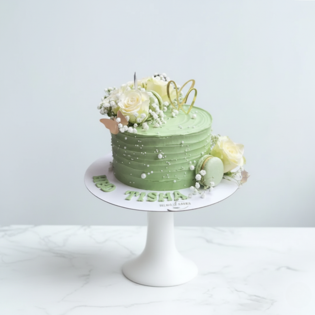 green cake with flowers and macarons for birthdays and other celebrations