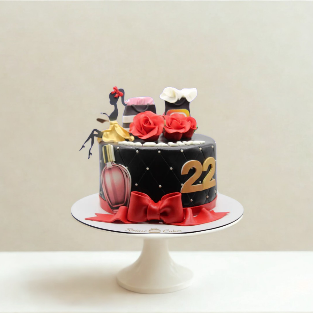 Decorative cake with fashion girl, flowers, and number 22 on a white stand against a beige background