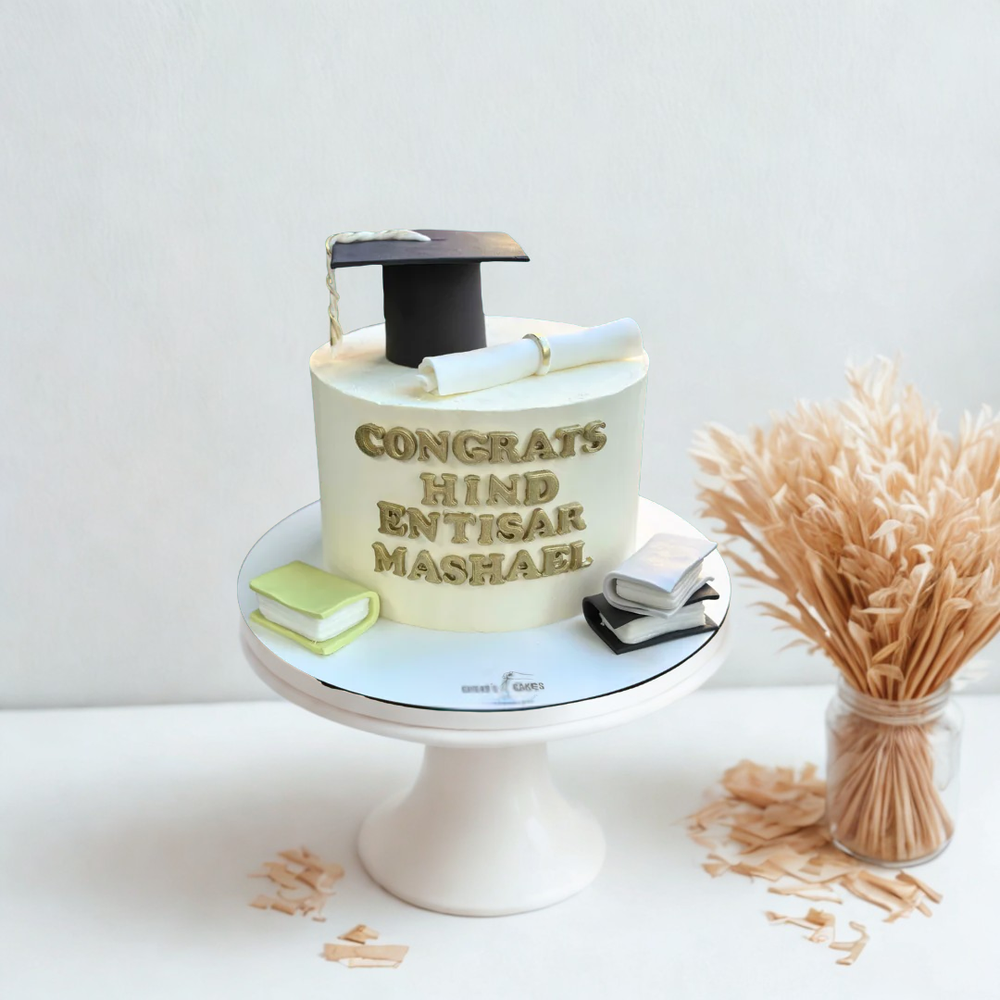 Graduation-themed cake with graduate hat books and diploma