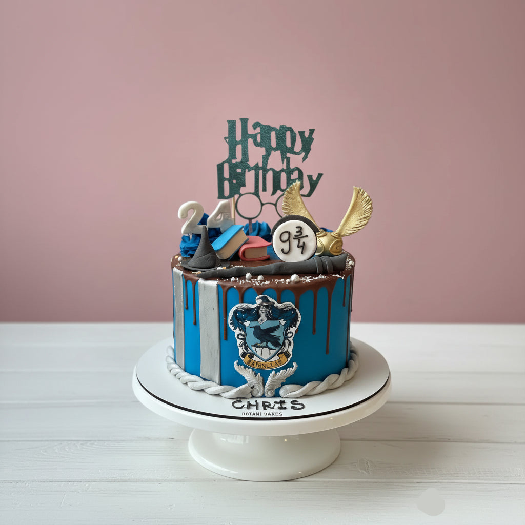 harry potter theme Blue birthday cake with decorative elements on a white stand against a pink background