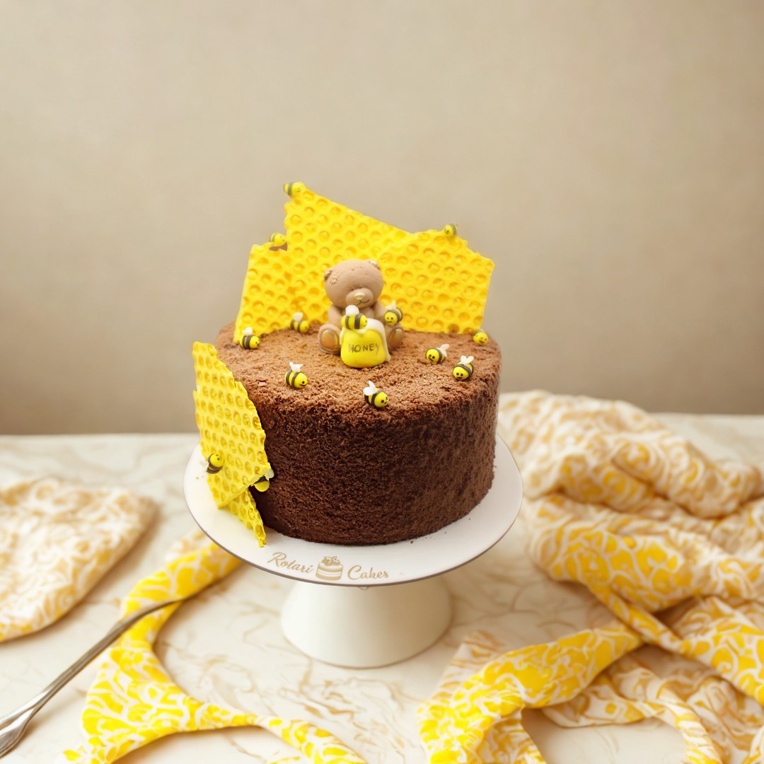 Chocolate and honeycomb on a white stand, featuring a bear figurine.
