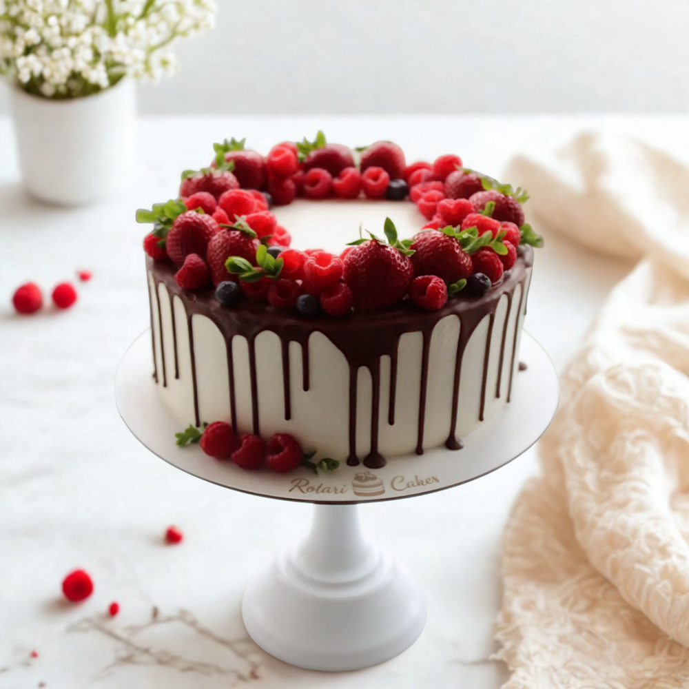 Decorative cake with berries on a white marble surface