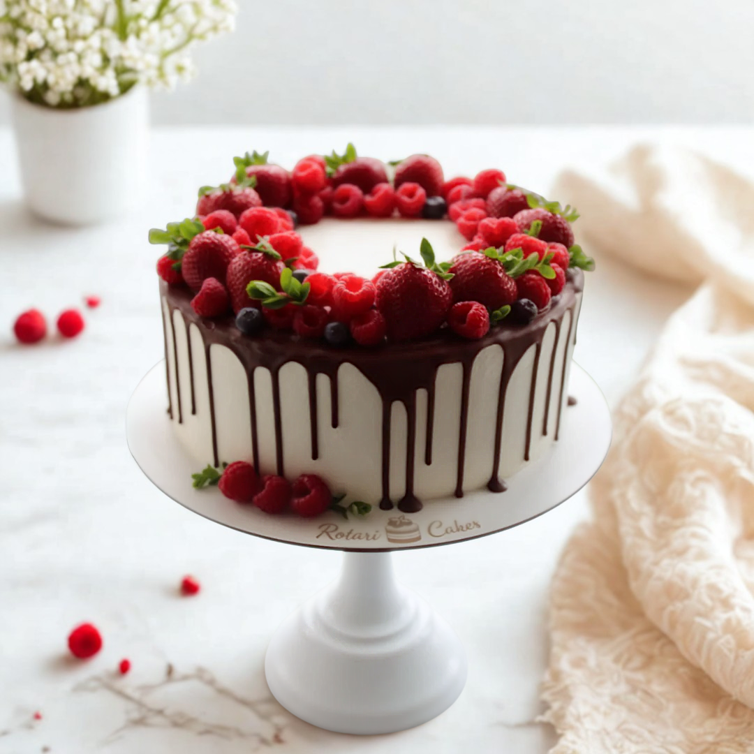 Decorative cake with berries on a white marble surface