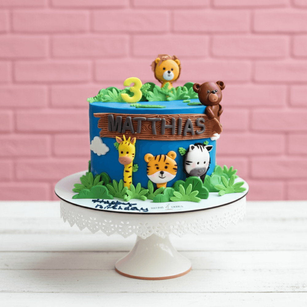 jungle theme Children's birthday cake with animal-themed decorations on a pink brick wall background