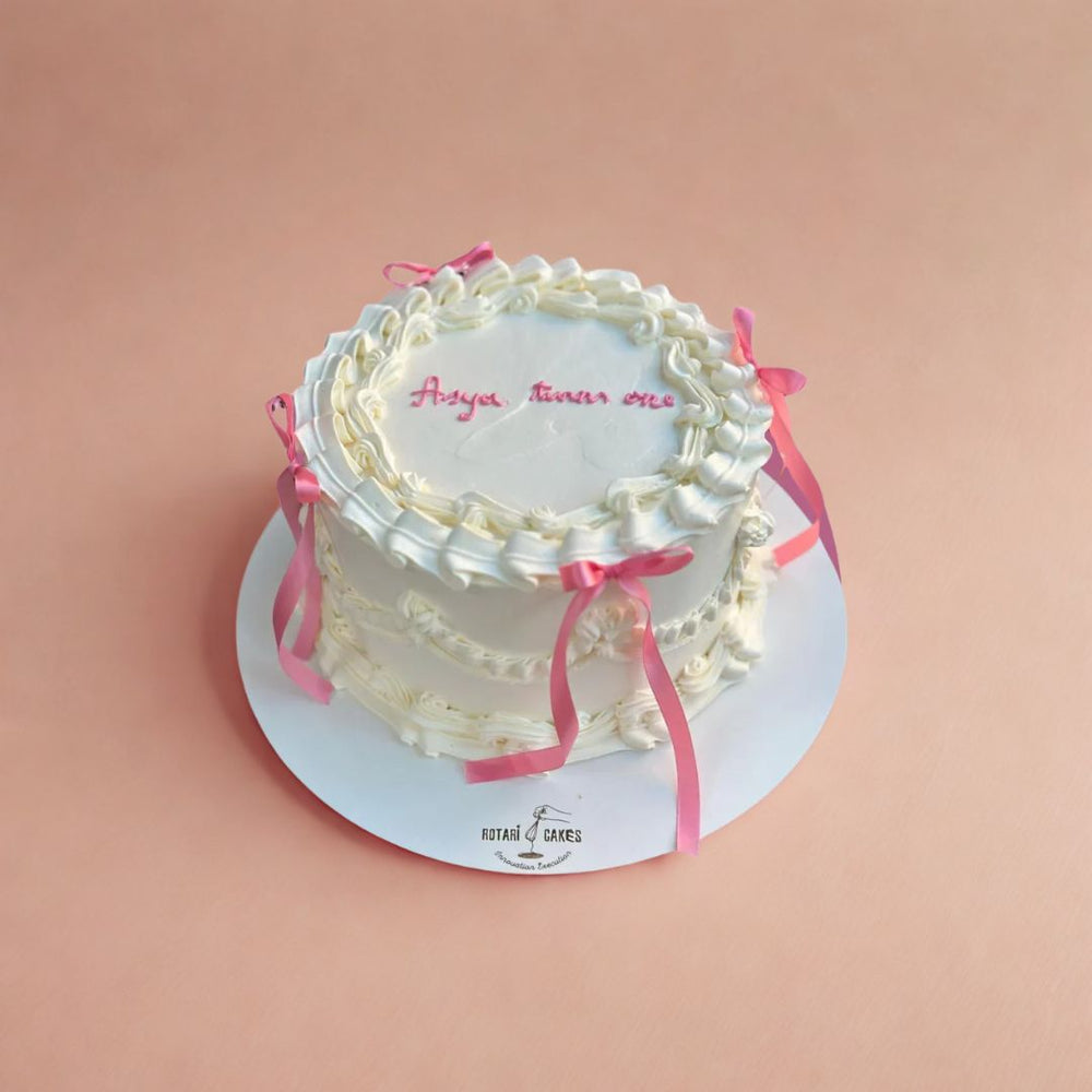 piping and bow cake in white colour
