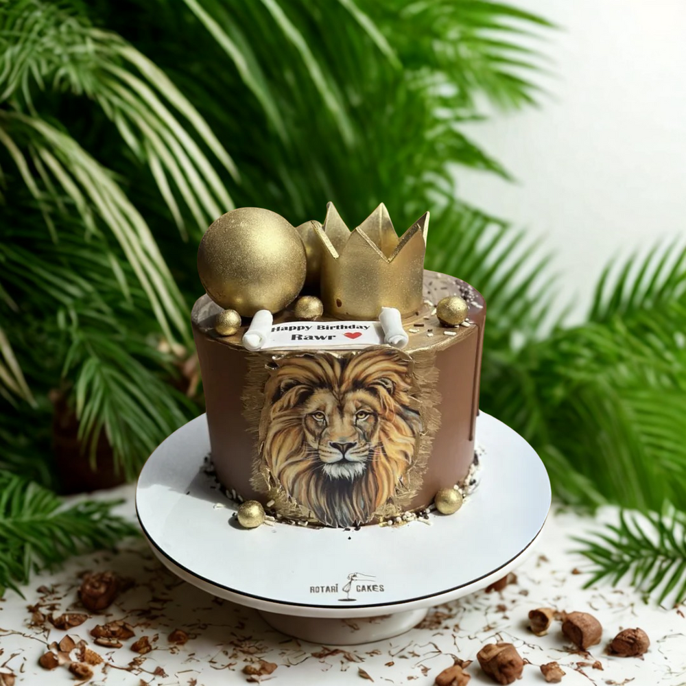 Birthday cake with lion design and gold accents 