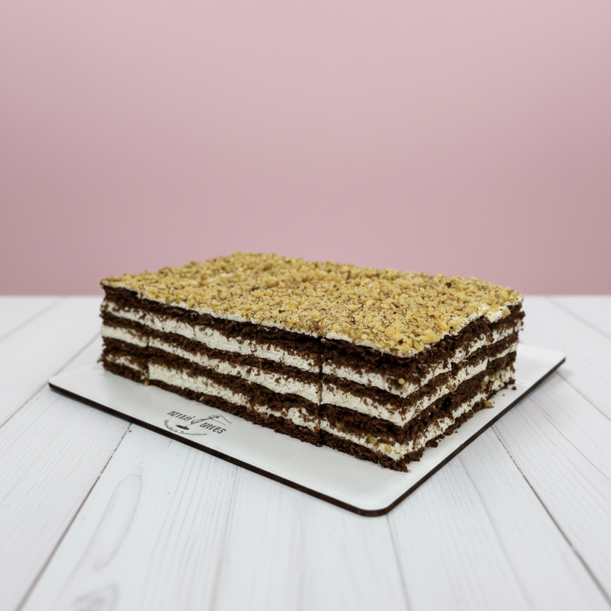 Layered cake on a white plate with a pink background
