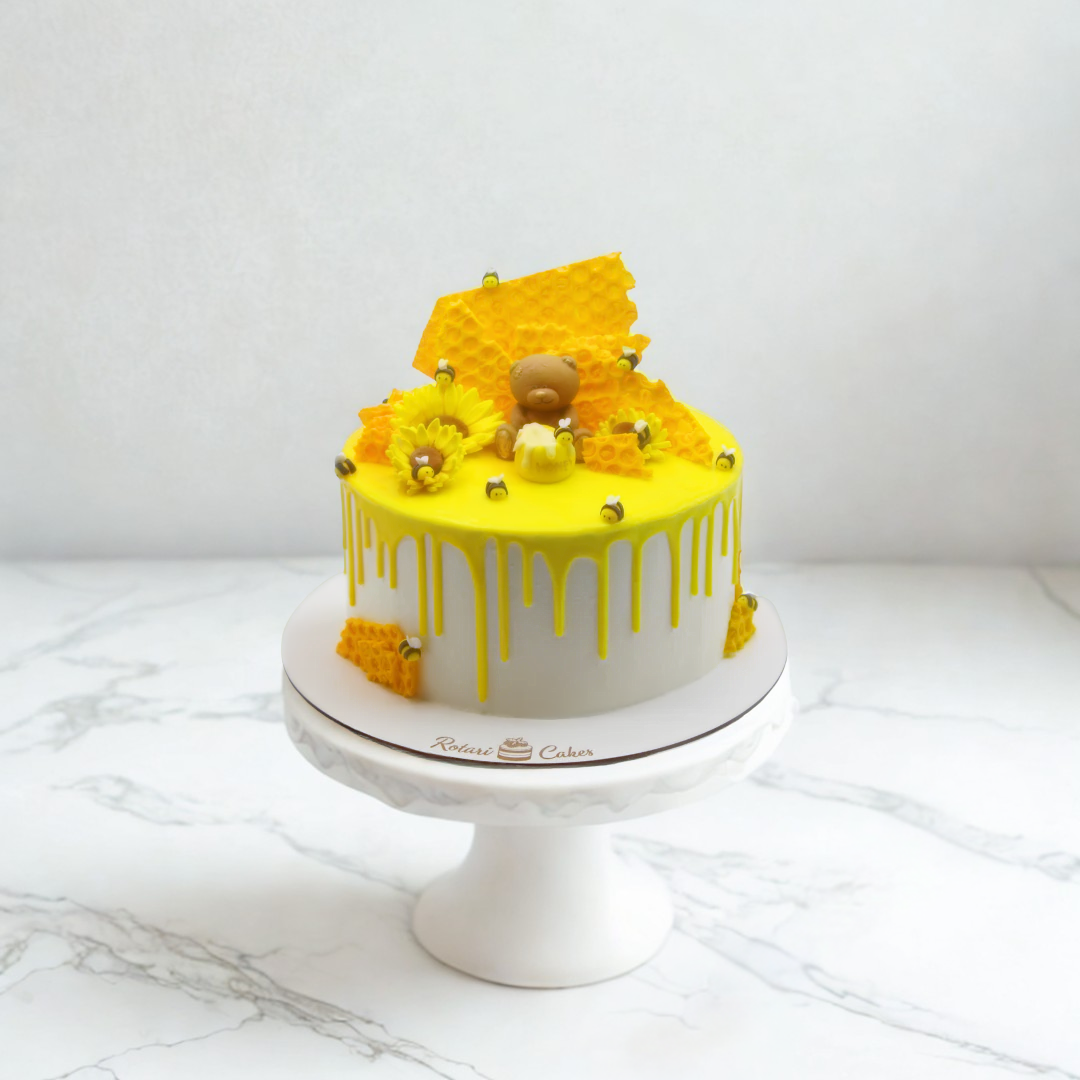 Yellow and white medovic cake with honeycomb decorations