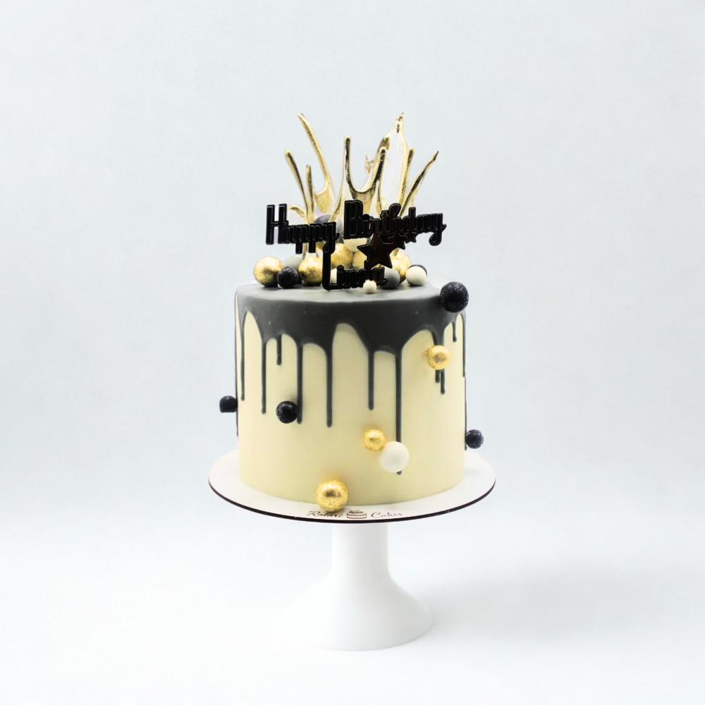 milky cake with black and gold elements for girls birthday