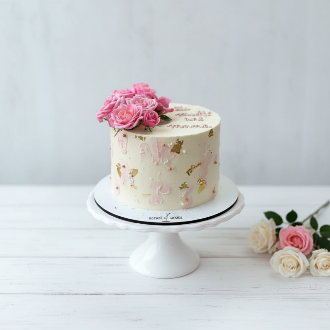 white mini cake with flowers on top