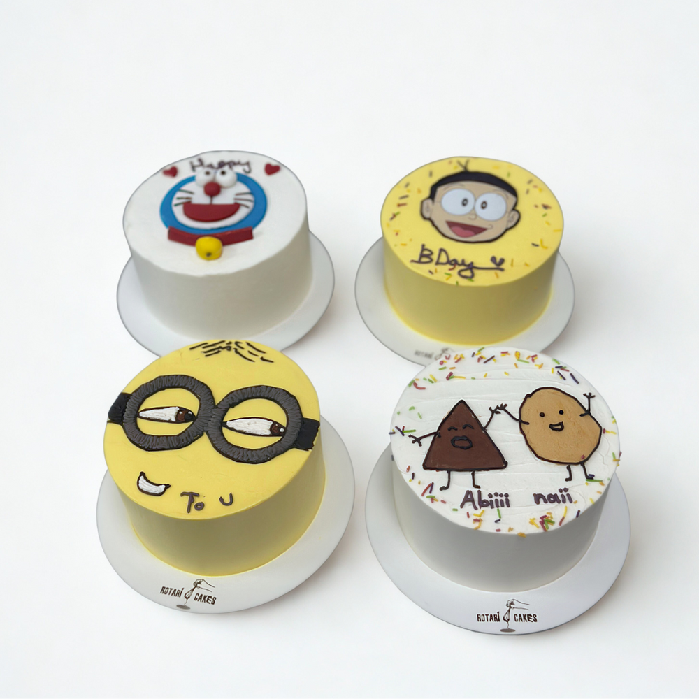 Mini cakes with colourful fondant designs including a Minion, cat face, and art-inspired details
