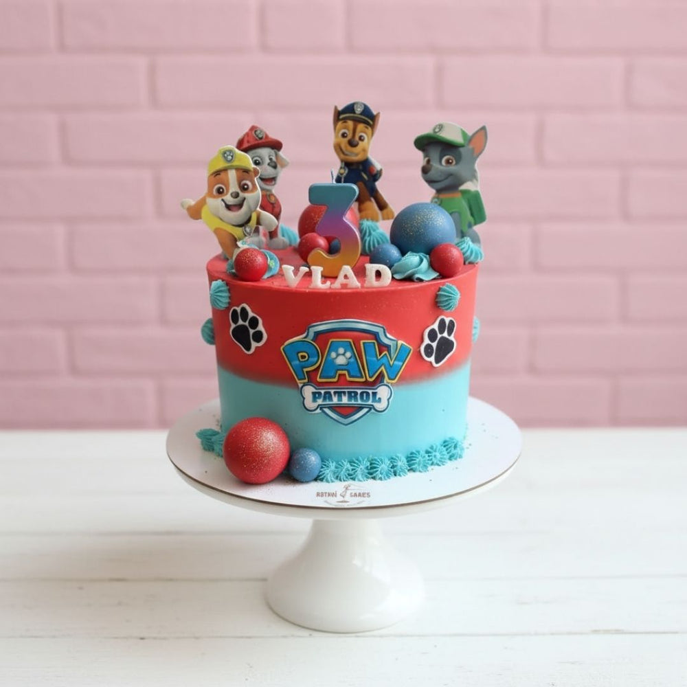 Paw Patrol birthday cake with cartoon characters on a pink brick wall background