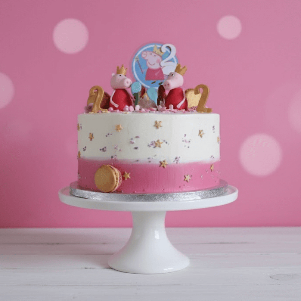 Birthday cake with Peppa Pig-themed decorations on a pink background