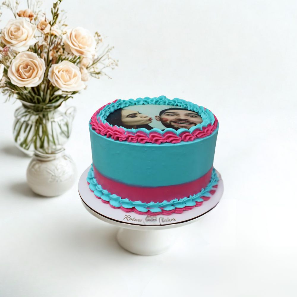 photo cake with pink trim on a white stand 