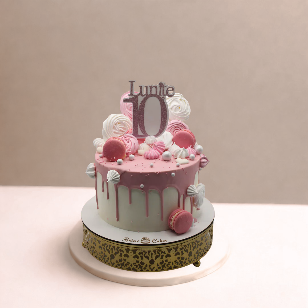 Pink birthday cake with decorative elements and 'Lunite 10' topper