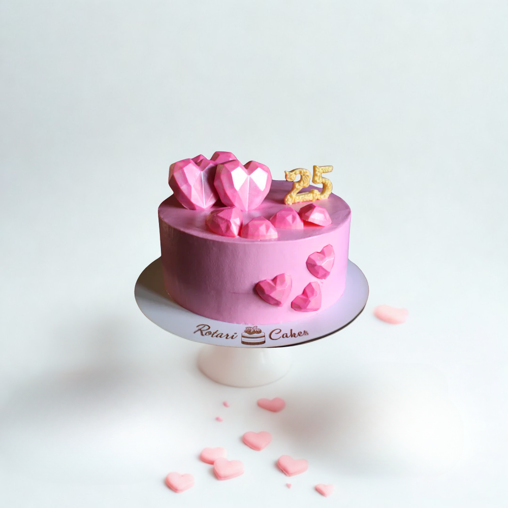 Pink cake with heart decorations and a '25' topper 