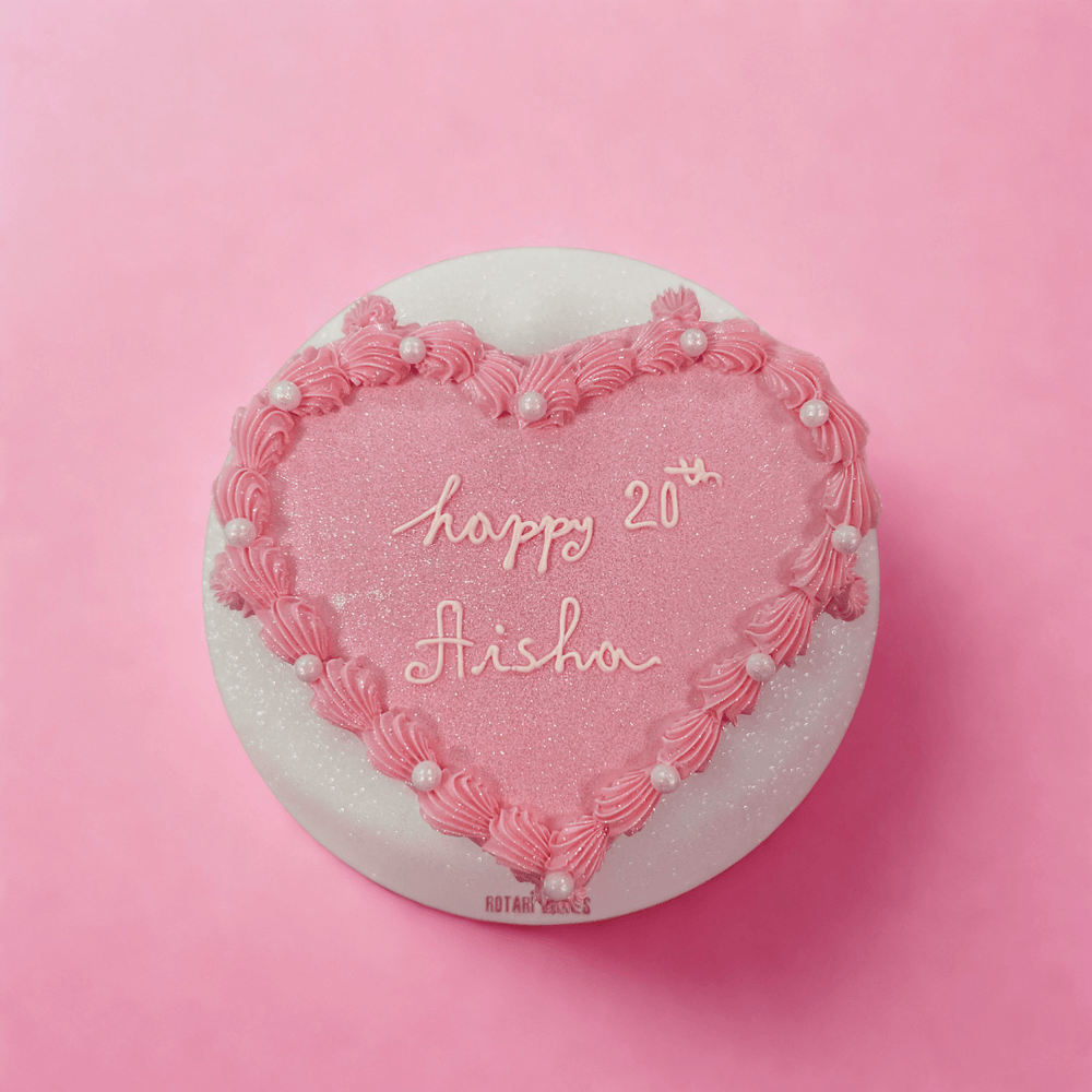 
                  
                    Heart-shaped pink cake with 'happy 21st Aisha' text on a pink background
                  
                