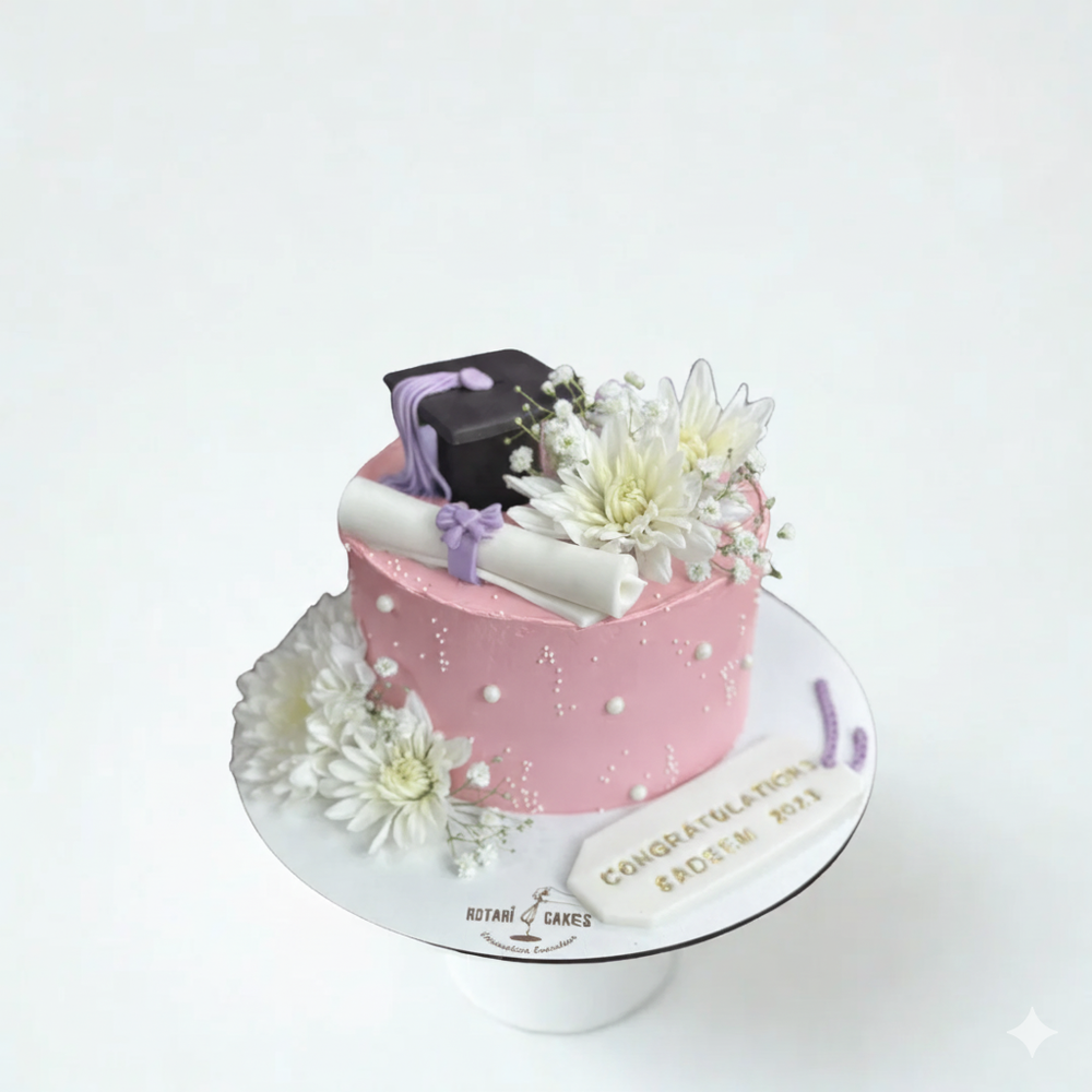 Pink cake with white flowers and a diploma decoration on a white background