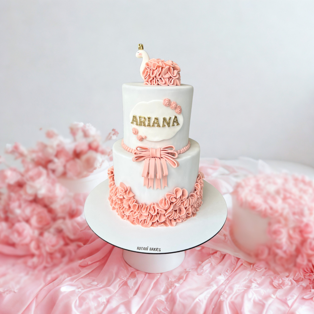 pink swan-themed cake with two tiers, and soft feminine design elements